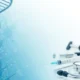 Blue DNA helix on left with medical tools including stethoscope and syringe on right.