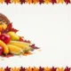Wicker cornucopia with pumpkins, apples, pears, corn, and autumn leaves on white background.