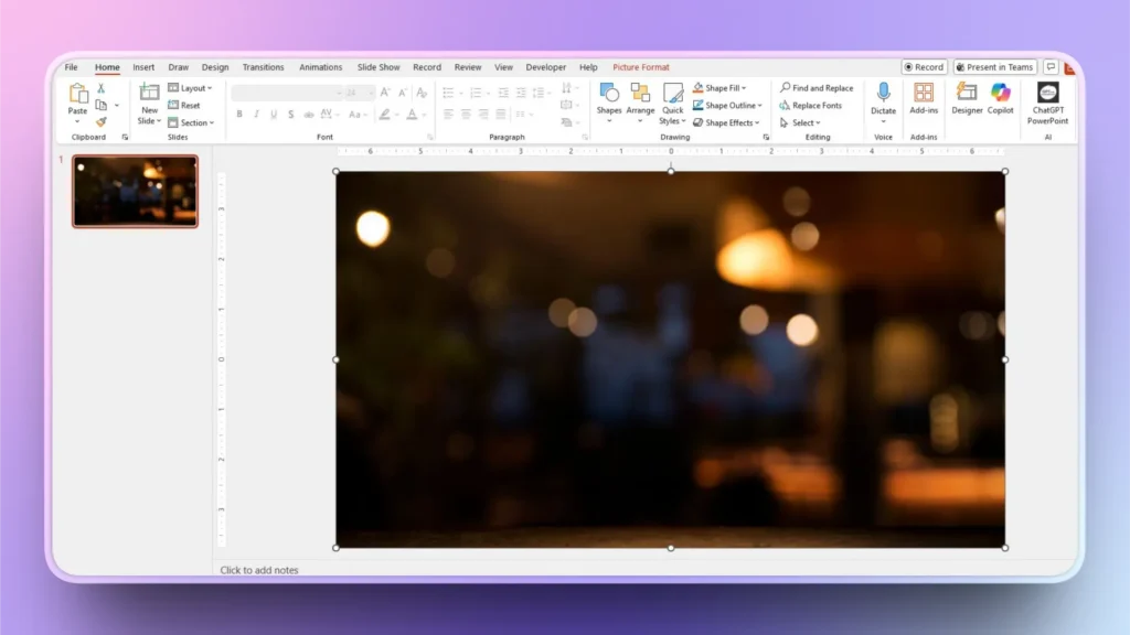 Screenshot of a PowerPoint slide with a blurred bokeh background image and visible toolbar options.