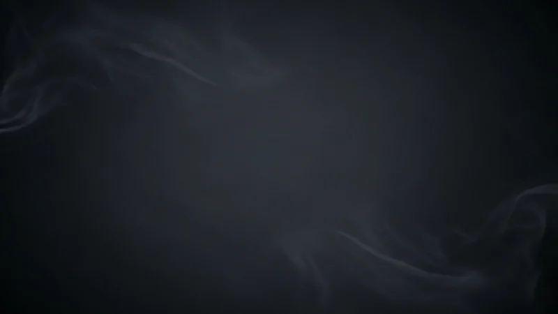 Dark background with subtle, wispy gray smoke curling across the edges.