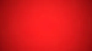 Solid red background with a subtle gradient and no distinct objects or text.