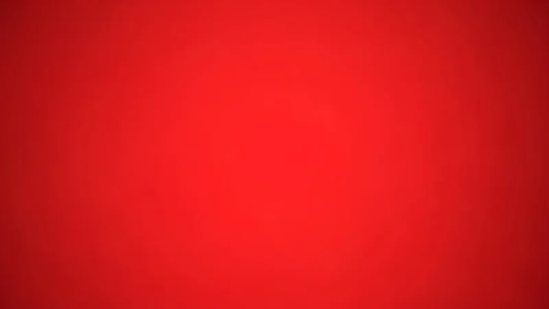 Solid red background with a subtle gradient and no distinct objects or text.