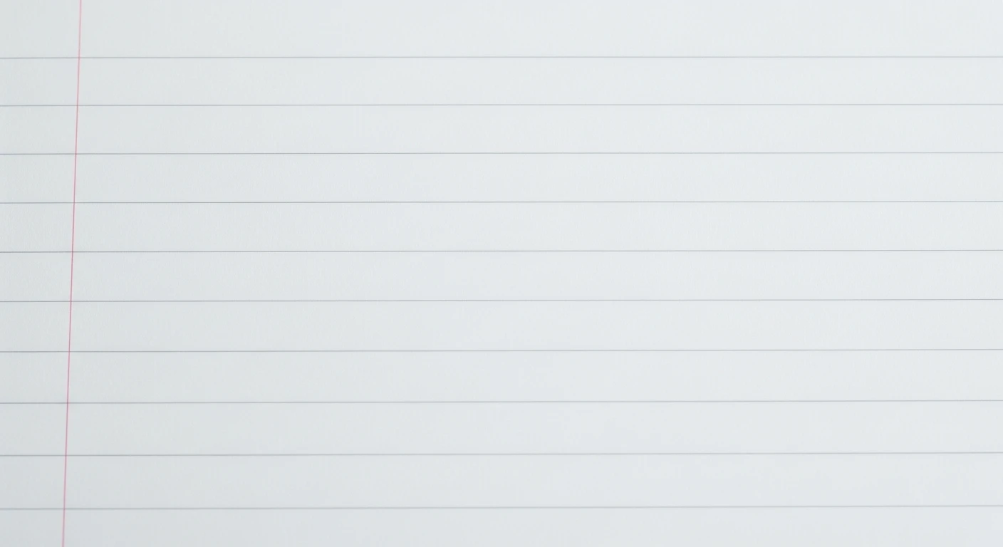 Close-up of a blank white lined notebook page with a red vertical margin line.