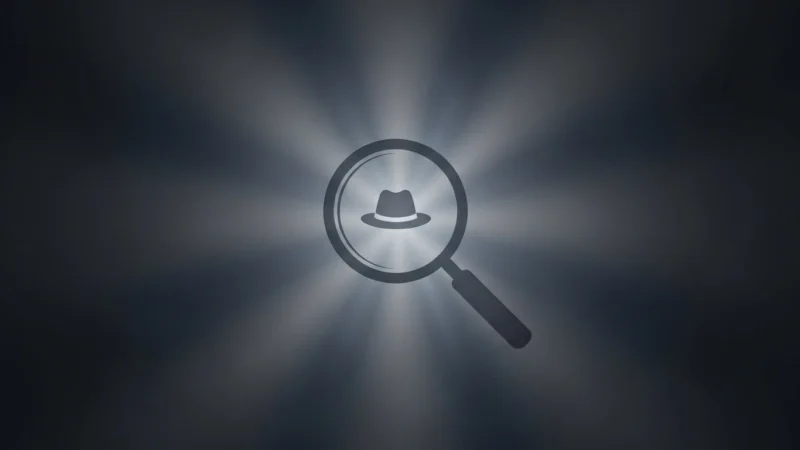 Magnifying glass icon focusing on a fedora hat symbol, with radial light beams on dark background.