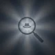 Magnifying glass icon focusing on a fedora hat symbol, with radial light beams on dark background.