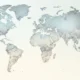 Stylized world map with continents in muted gray and beige shades on a light background.
