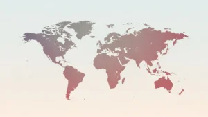 Faded world map with continents in gradient shades of gray and red on a light background.