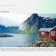 Scenic Norwegian fjord with towering rocky cliffs, calm water, and red wooden houses on stilts.