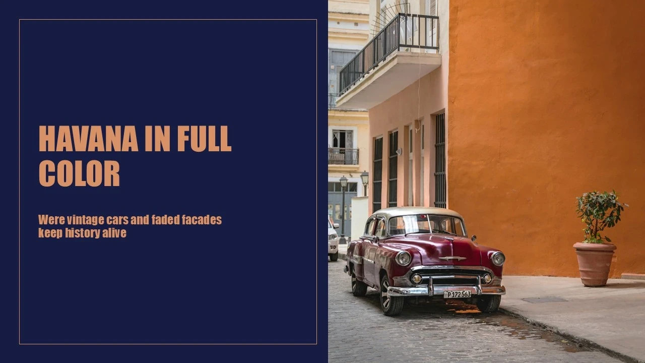 Vintage maroon car parked on a cobblestone street beside orange and peach building facades.
