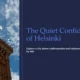 Red brick tower with Finnish flags against a blue sky, accompanied by text about Helsinki.