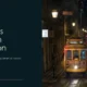 Nighttime view of yellow Tram 28 on illuminated street in Lisbon, Portugal.