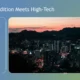 Cityscape at dusk with illuminated skyscrapers and silhouetted mountains under a colorful sky.