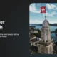 Aerial view of Zurich with a historic tower flying the Swiss flag against a partly cloudy sky.