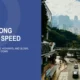 Urban highway in Hong Kong with vehicles, skyscrapers, greenery, and cloudy sky.