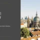 Alt text: Panoramic view of Vienna's historic skyline featuring a large domed cathedral with spires under a clear sky.