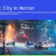 Nighttime snowy street scene in Toronto with pedestrians, vehicles, and illuminated buildings.